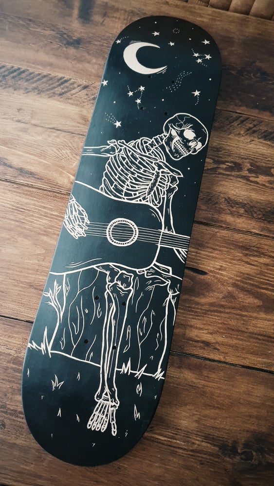 Skeleton Playing Guitar Under the Stars skate deck