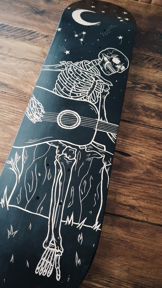 Skeleton Playing Guitar Under the Stars skate deck